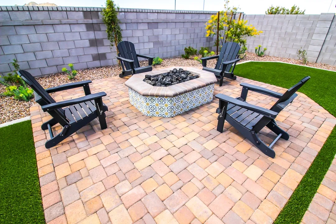 Backyard patio with a built-in stone fire pit.